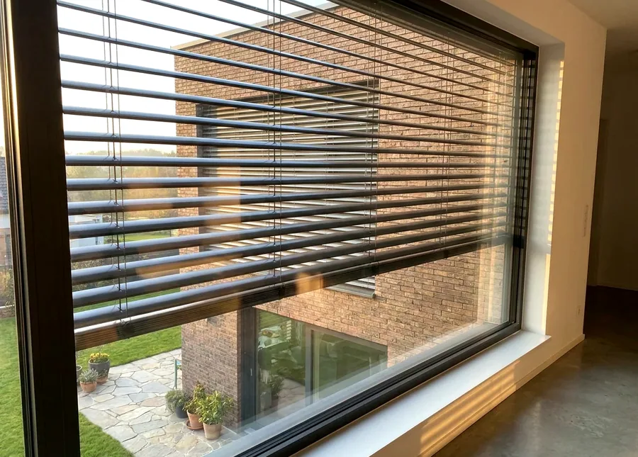External aluminium venetian louvres shading an Illovo apartment block facade against afternoon sun